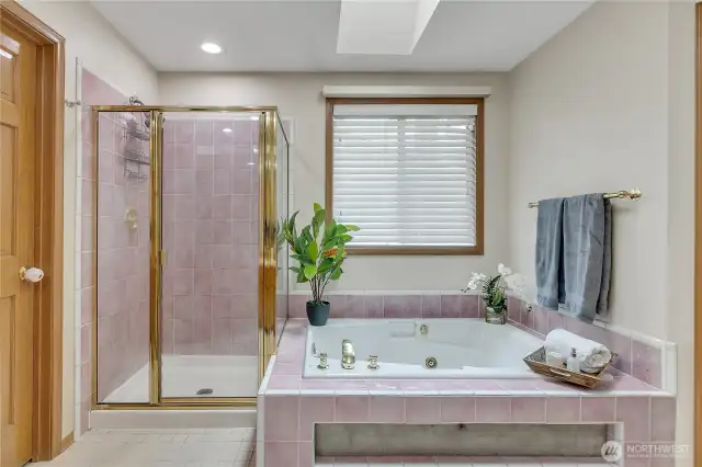 The primary full bath boasts a large jetted tub offers a space to unwind and relax. It’s the perfect retreat for a soothing soak after a long day.