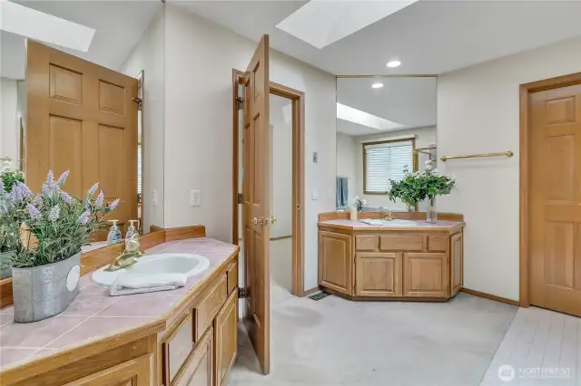 The primary bath features dual vanities, providing ample space for both functionality and comfort. It’s an ideal setup for busy mornings.