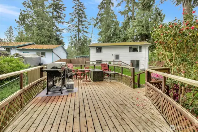 Large deck overlooking the back of the property