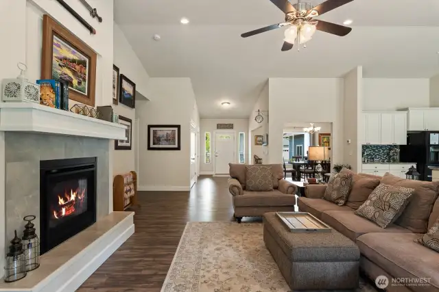 Great room with vaulted ceilings, beautiful fire place with tile surround.