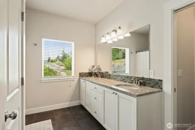 Primary bath with tall vanity, double sinks, and separate water closet.