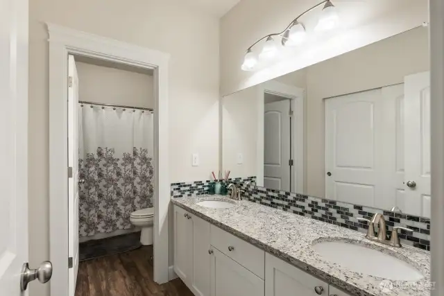 Full guest bath with separate tub/shower and toilet. Dual vanity is separated out.