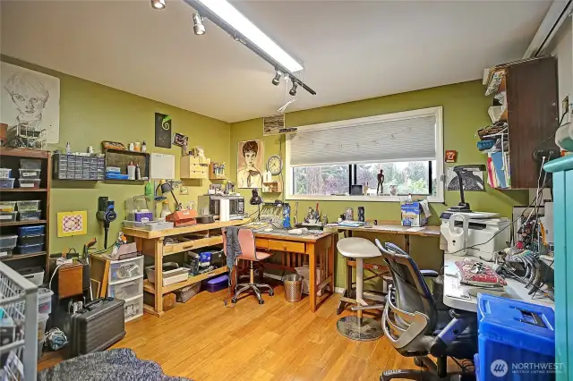 One of the bedrooms is being used as a craft room for hobbies.