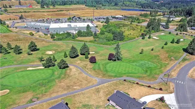 Aerial view of the golf course and Camano Plaza for all your local shopping needs. Both are a golf cart ride away!