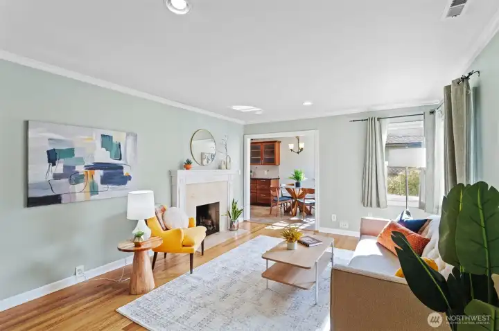Bright and open living room with wood burning fireplace.