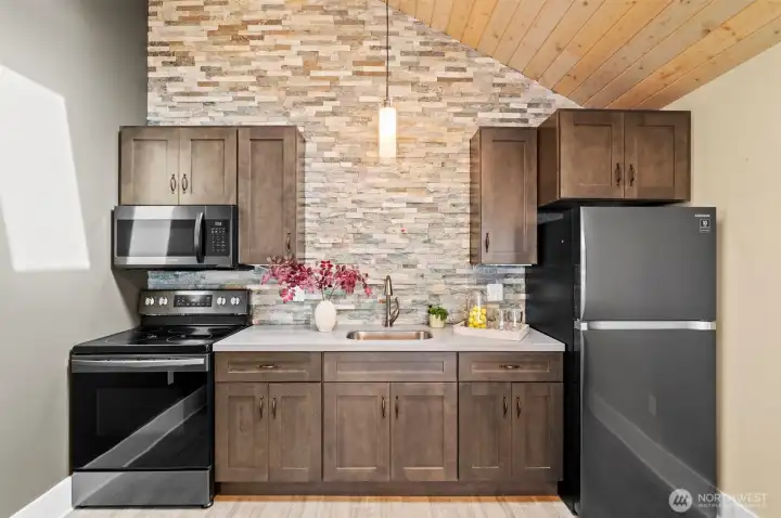 Appliances stay! Also features a full stone wall and cabinet lighting.