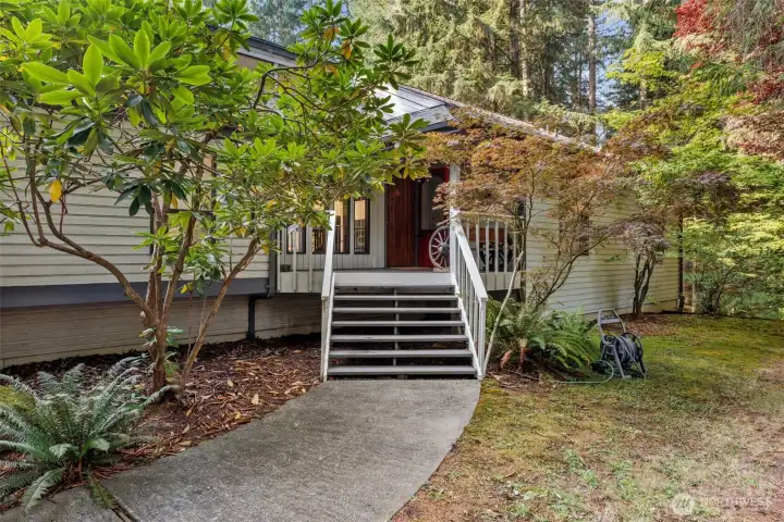 Entrance with mature landscaping.