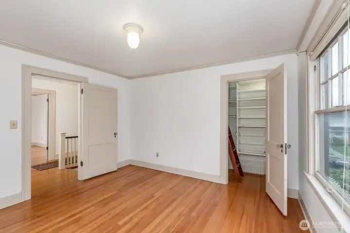 NE bedroom offers access to attic area.