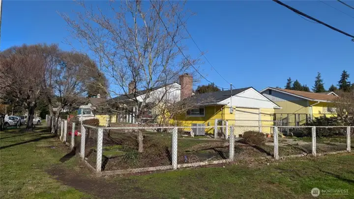 Corner Lot has large front yard & room for parking