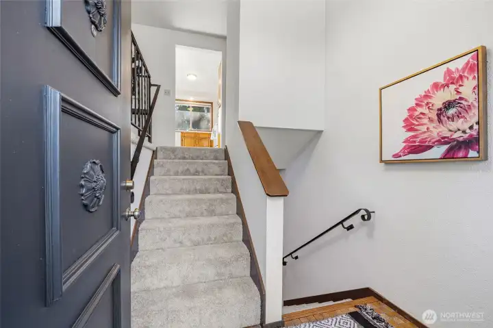 Welcoming entry landing creates a natural transition between levels, enhanced by brand-new carpet for a fresh, inviting feel.