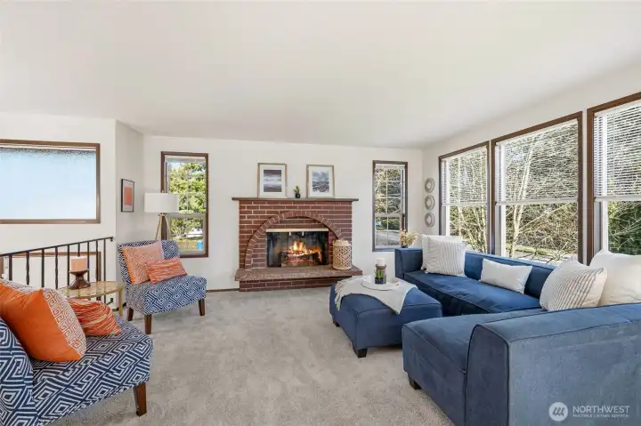 Unique window design adds warmth, light, and personality to the living area.