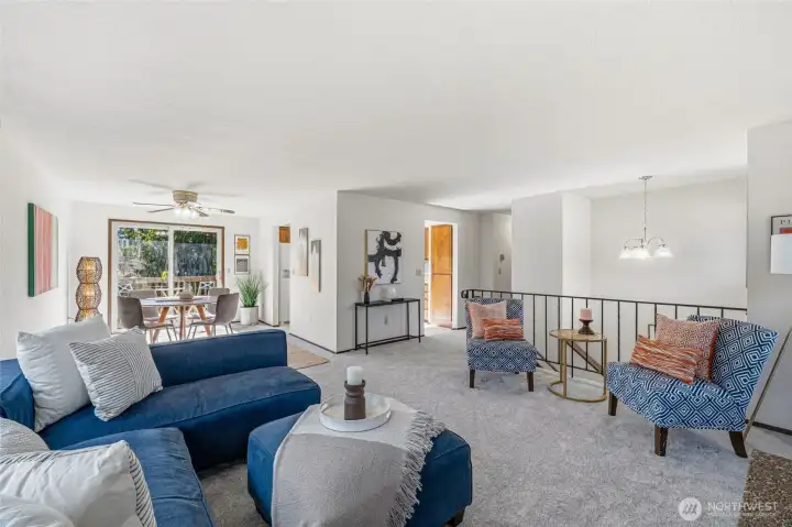 Bright and inviting living room seamlessly flowing into the dining area, creating a comfortable and connected living space.