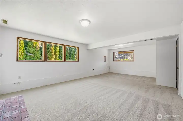 Lower-level living space enhanced by strategic window placement, providing excellent natural light.