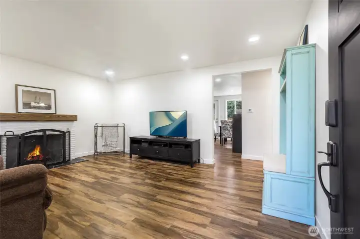 Enter to the living room with wood burning fireplace.