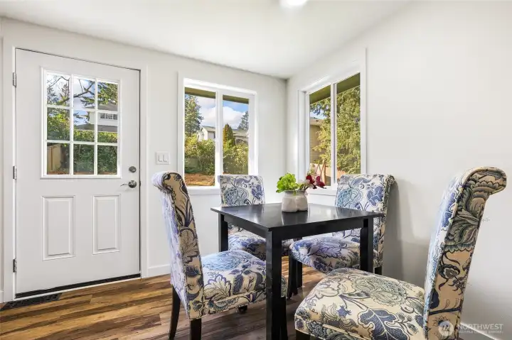 Dining area in the kitchen, with back yard access.
