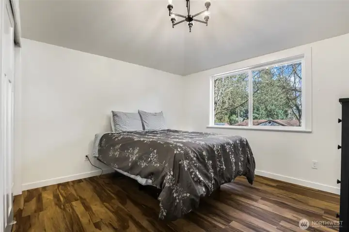 Primary bedroom with vaulted ceilings.