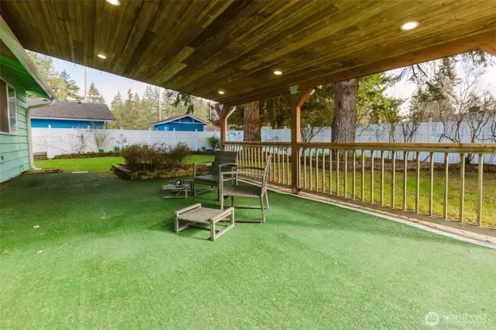 Large covered back deck withs cedar lined ceiling