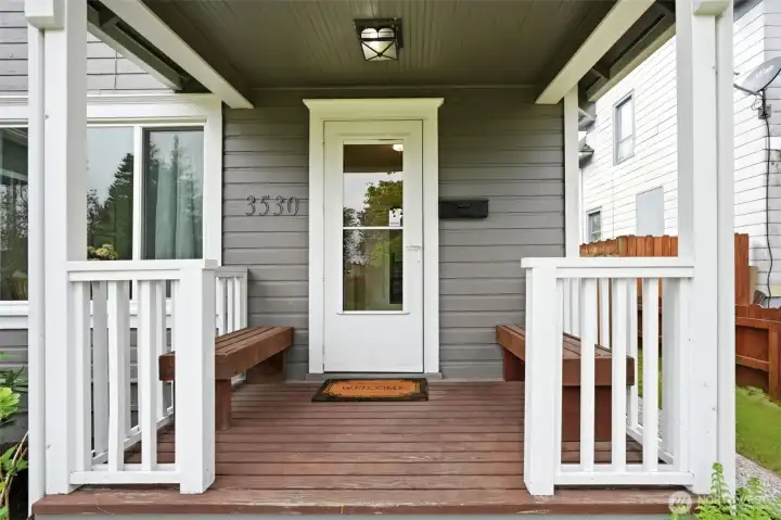 Charming covered front porch with built-in seating