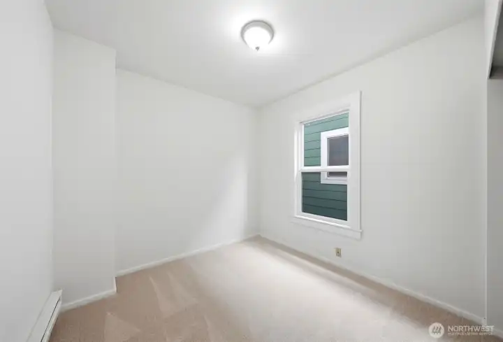 Two bright and versatile main-level bedrooms provide flexible living options, ideal for guests, work-from-home needs, or additional living space