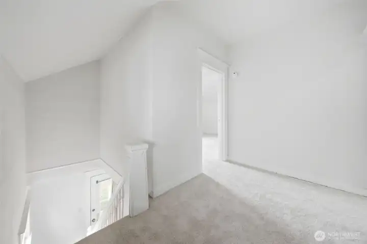 Light-filled upper landing leading to bedrooms and full bath