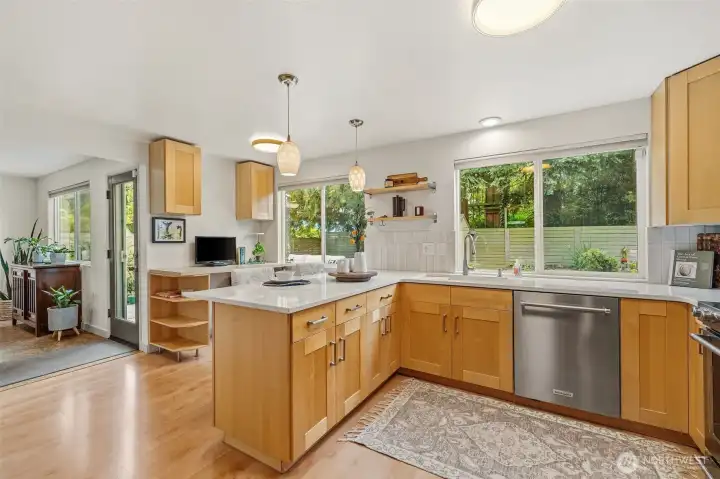 Quartz counters. Stainless appliances eat in kitchen