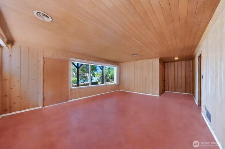 Spacious lower level with large windows glazing across the lake.