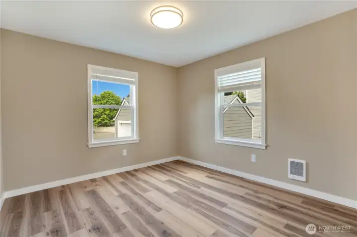 Located at the back of the home, the primary bedroom delivers privacy and versatility—equally suited for restful living or a dedicated office.