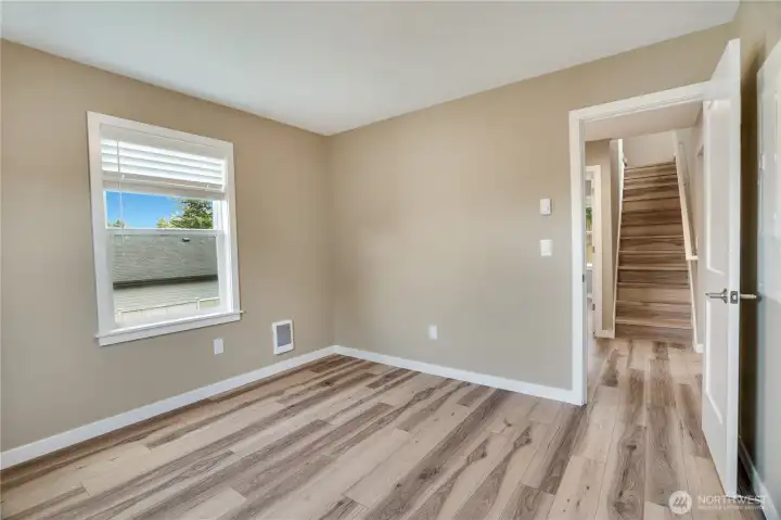 Here’s an additional look at the largest bedroom on this floor—the primary—showing off its spacious footprint and versatility.