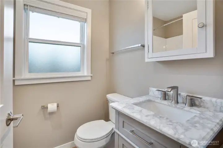 Here’s the refreshed bathroom, featuring a new vanity with quartz counters, an updated toilet, and fully renewed finishes from top to bottom.