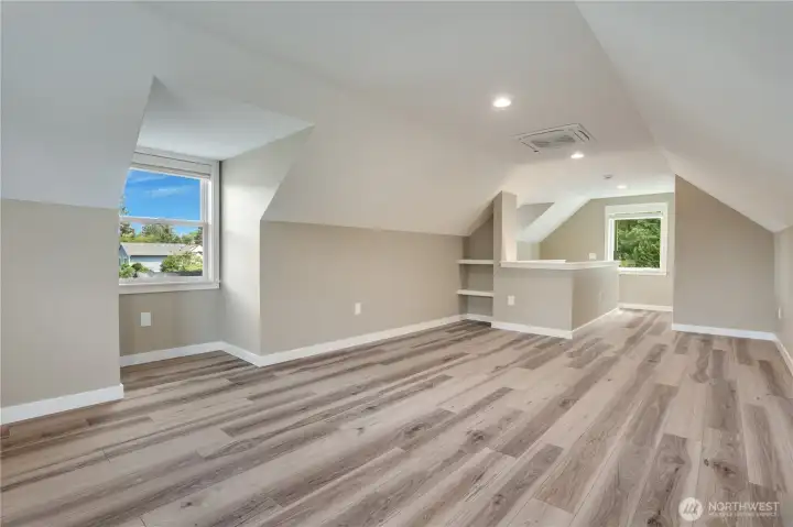 Another view of this upstairs space highlights its open layout and updated finishes.