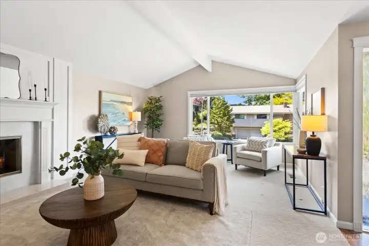 Formal living room with gas fireplace, vaulted ceilings and beam