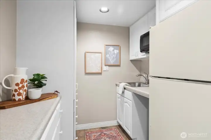Kitchenett with fridge, sink and microwave on lower level