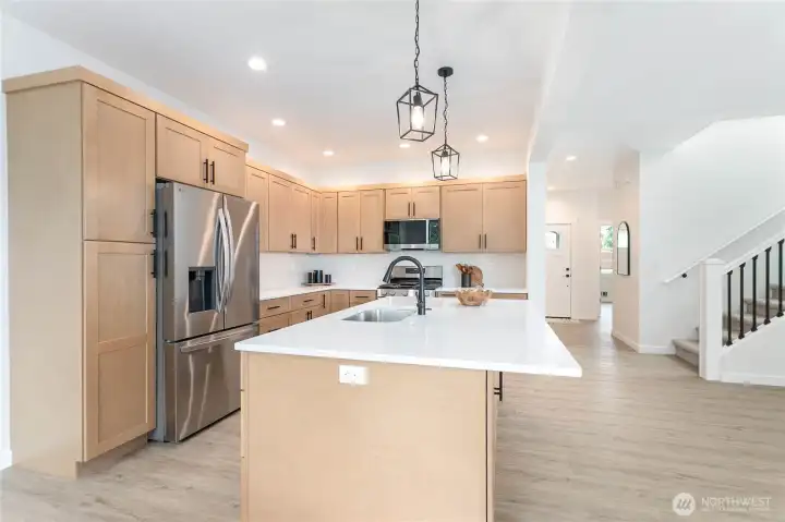 Beautiful quartz countertops and tiled backsplash!