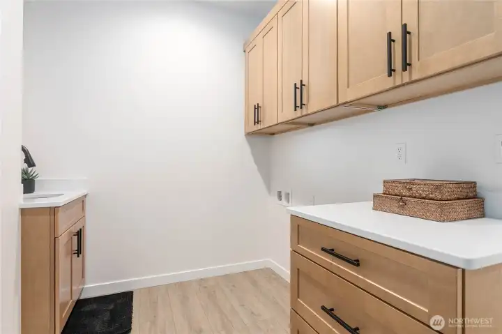 The utility room has a lot of additional storage and is located off of the garage entrance.