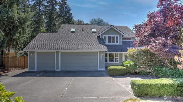 Charming two-story home in the quiet Springbrook Terrace neighborhood radiates warmth & elegance. Welcoming covered front porch! Enter to grand staircase, hardwood floors & new carpets on the main floor. Living room surrounded by walls of windows & cozy gas fireplace. Open concept kitchen w/ views to private yard, granite counters, breakfast bar & dining space. Main floor office w/ elegant wainscotting. Access to wrap around deck for outdoor entertaining. Family room has custom stone gas fireplace, built-in surround sound and French doors to the expansive deck. Upstairs has a spacious primary suite w/sitting room, walk-in closet & spa-like en suite. Enjoy two more generous sized guest rooms upstairs & full guest bath. Backyard lined with privacy shrubs featuring an extended patio & entertainment-sized deck. Covered lower deck & patio. Huge stand-up crawl space is set up for storage/shop! Newer roof! Commuting is a breeze & close to all ame