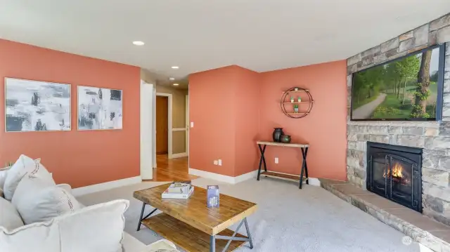 Family room with custom stone gas fireplace, built-in surround sound and French doors guiding you to the wrap-around deck.  his spacious family room offers a second fireplace wrapped in stone from floor to ceiling for that WOW factor.