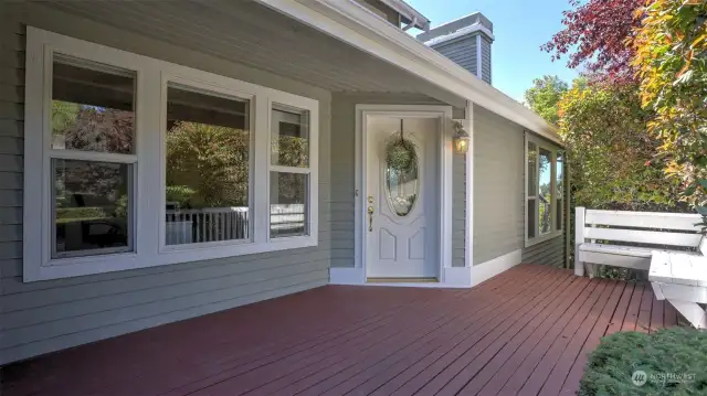 Quaint covered front porch with built-in bench welcomes guests and a perfect space to enjoy your morning coffee!