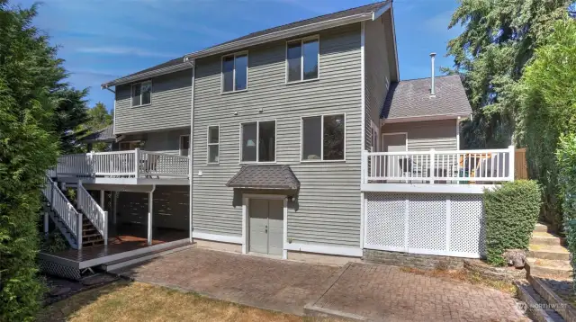 Views of the back of the home showing all the outdoor seating spaces.