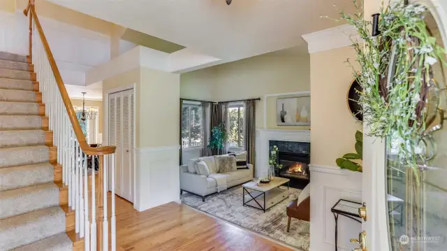 Open entryway showcasing the true elegance and open-concept of this home. Grand staircase, gleaming hardwood floors and soaring entry flooded with natural light.