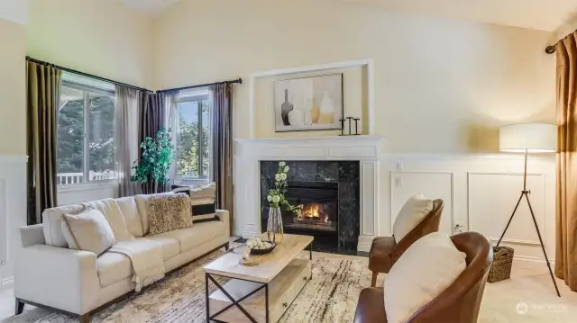 Enjoy this cozy front living room with gas fireplace, vaulted ceilings and wall of windows. This space is great for entertaining or a quiet night in curled up with a good book.