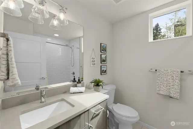 This stylish bathroom features contemporary fixtures and finishes, including a sleek vanity and elegant lighting, creating a spa-like atmosphere for daily routines.