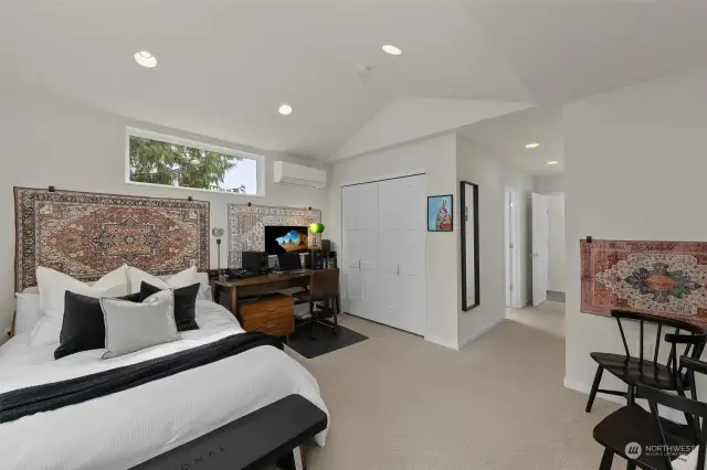 Another view of the primary bedroom showcasing the open space.