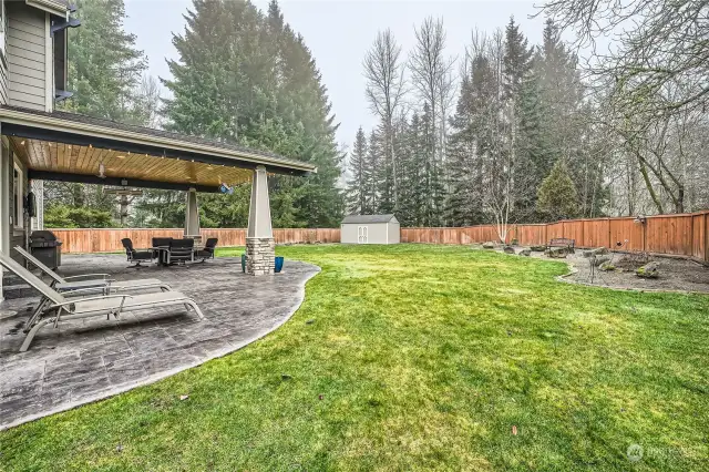 Spacious, fully fenced backyard with shed and garden space