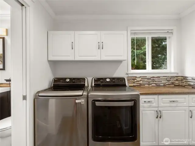 Laundry area with Washer/Dryer included, on the main level, near the garage and upstairs guest bathroom.