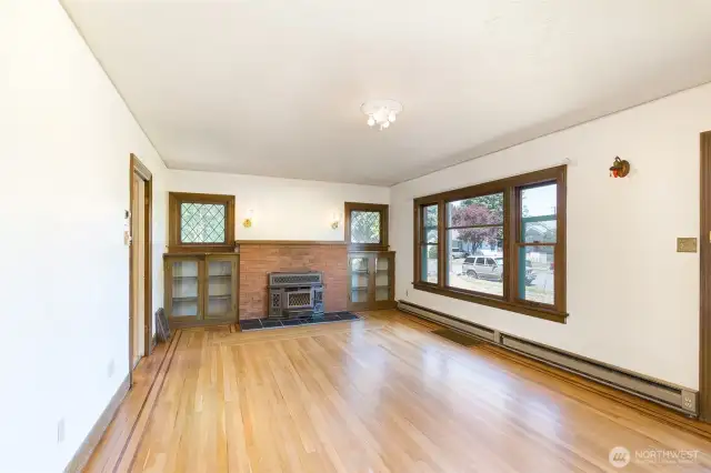Original built-in bookshelves surround the wood fireplace inset.