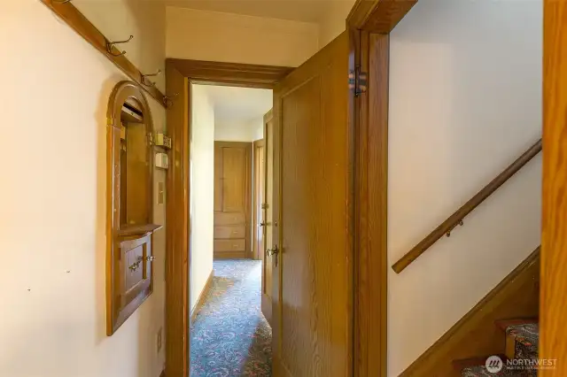 Hallway leading to 2 lower bedrooms and full bathroom with phone booth built in!