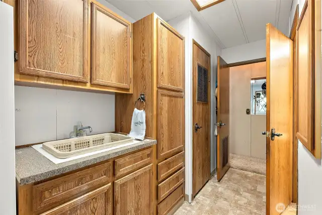 Entry way from carport. Large space with w/d + fridge/freezer hookup