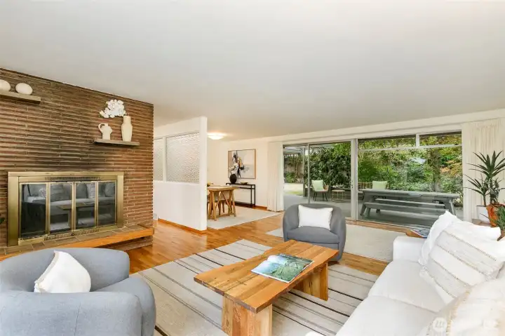 Light-filled living room features a wood-burning fireplace.