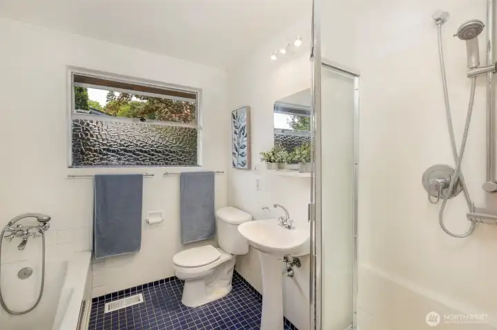 Main level bathroom features a separate bath and shower.