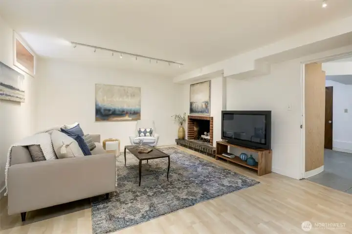 Spacious family room features wood-burning fireplace.